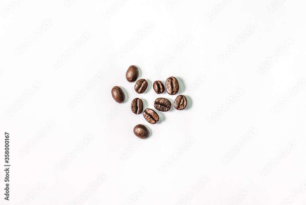 Closeup shot of coffee beans on white background. Seed nature from above view. Group agriculture grain arabica. Photos from the top view. Closeup shot of coffee beans on white background. Seed nature from above view. Group agriculture grain arabica. Photos from the top view.