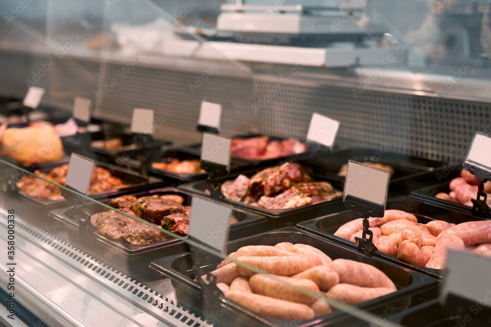 Raw meat products in glass counter. Raw meat products in glass counter.