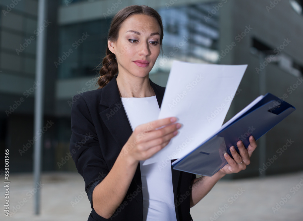 Businesswoman is examining documents