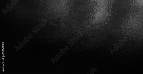 Black foil gradient texture background with uneven surface