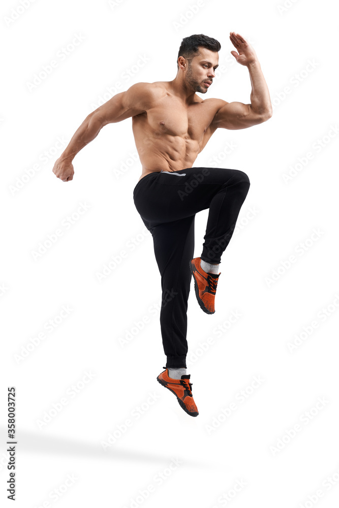 Shirtless bodybuilder jumping in place. Shirtless bodybuilder jumping in place.