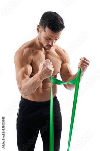 Bodybuilder training arms with resistance band.