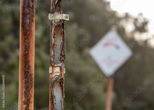 corroded sign posts on Tannum Sands beach, Gladstone Region, Queensland