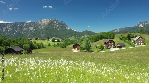 Flying over a flower meadow to Bad Aussee, Austrian Alps, Salzkammergut, Ausseerland, Austria