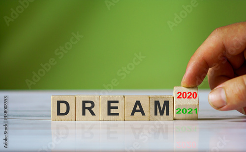 Hand turn wooden cube block and changes the word 