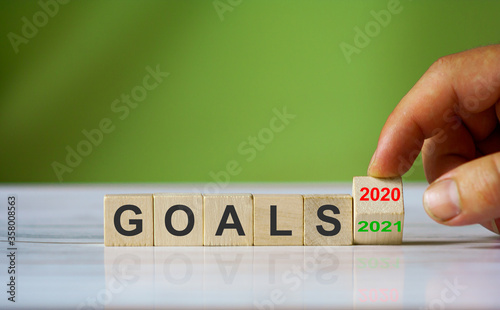 Hand changes the word "Goals 2020" to "Goals 2021"
