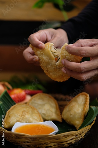 Jalangkote. Traditional fried puff pastry pouch from Makassar (Ujung Pandang), Jalangkote is a fried pastry filled with vegetables, minced beef and slices of boiled egg. Eat with watery chili sauce.  photo