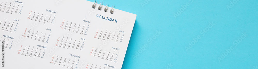 calendar page close up on blue background business planning appointment meeting concept calendar page close up on blue background business planning appointment meeting concept