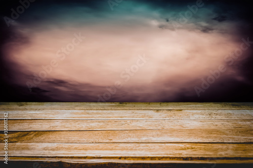 Old wooden table with dark horror texture background for Halloween season concept. Copy space for text and ideal for product placement.