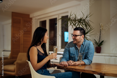 Couple enjoying at home with a drink, portrait.