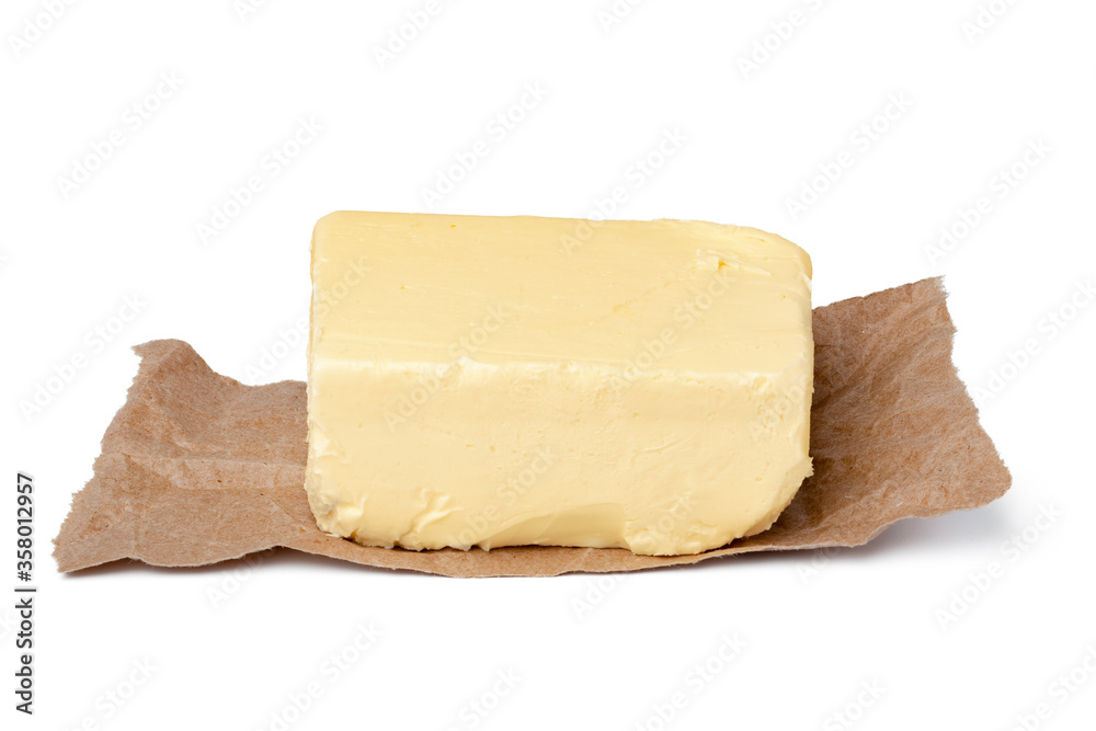 Fresh butter on craft paper isolated on white background
