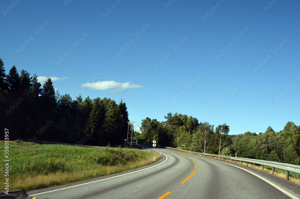 A typical Norwegian road in the countryside.  Ostfold Region, Norway