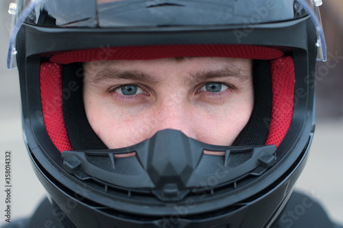 Direct view of a motorcyclist in a helmet with an open visor © Вячеслав Думчев