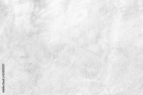Abstract weathered texture stained old stucco light white and aged paint concrete wall background in the room.