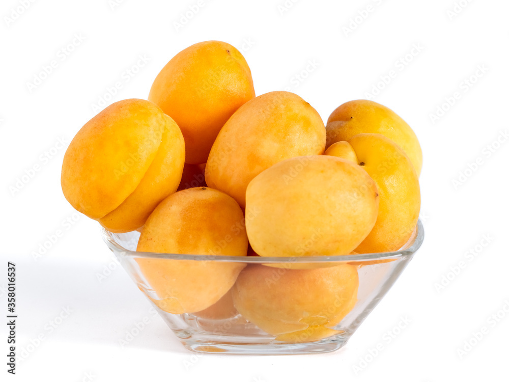 Apricots in the glass bowl isolated on white background, healthy food Apricots in the glass bowl isolated on white background, healthy food