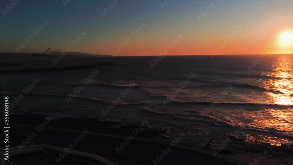 Beautiful Sunset from beach, Ericeria, Portugal, aerial drone view, panning shot