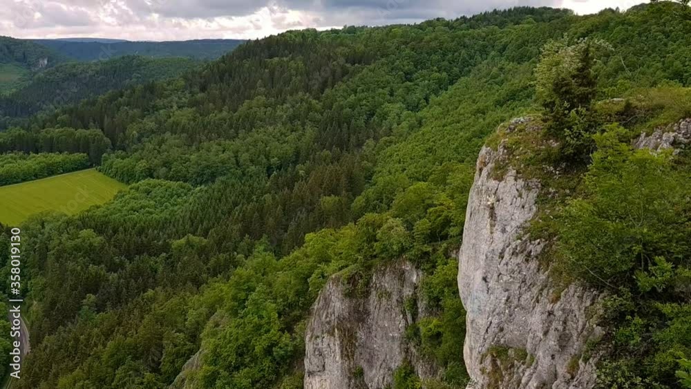 Panning up off white rock formation on mountain to beautiful landscape, Eichfelsen Germany. Panning up off white rock formation on mountain to beautiful landscape, Eichfelsen Germany.