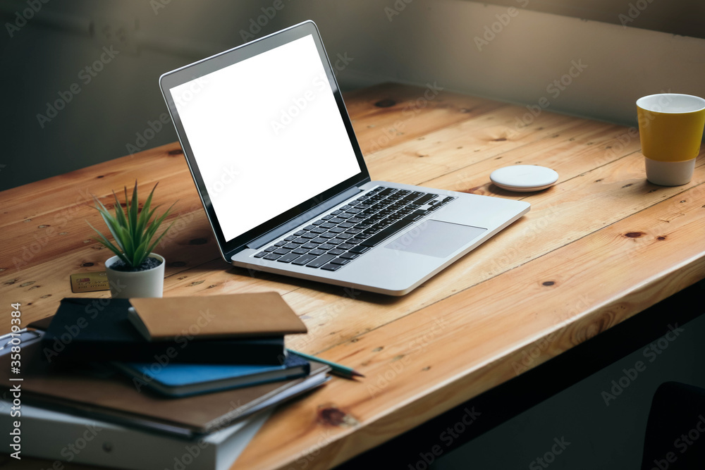 Workplace with laptop white blank screen in home office Workplace with laptop white blank screen in home office
