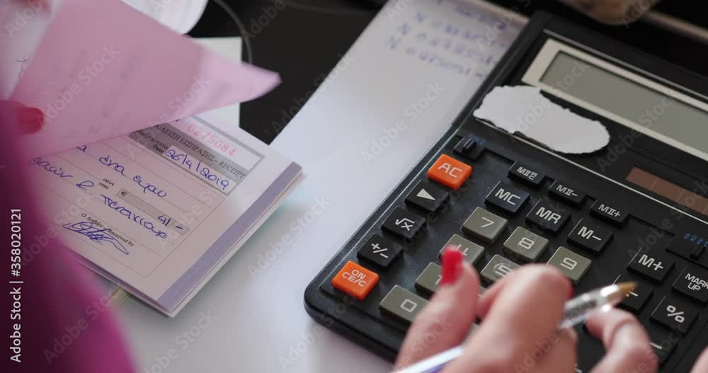 Close Up And Pan Of Female Accountant Using Calculator To Calculate Sales Receipts Close Up And Pan Of Female Accountant Using Calculator To Calculate Sales Receipts