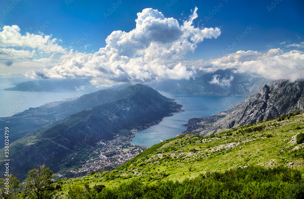 Montenegro Kotor Bay famous Adriatic sea fjord mountains town landmark travel tourism destination old city architecture cityscape harbor mediterranean view panorama. Bright clouds sunny summer day