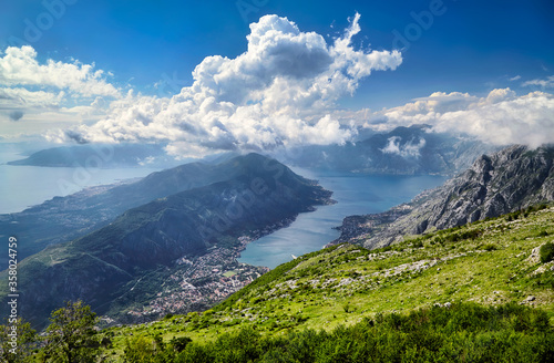 Montenegro Kotor Bay famous Adriatic sea fjord mountains town landmark travel tourism destination old city architecture cityscape harbor mediterranean view panorama. Bright clouds sunny summer day
