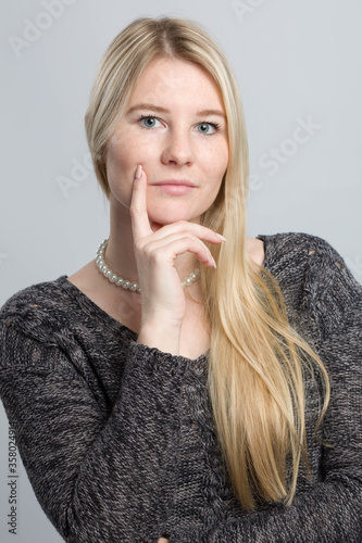 young blond woman is thinking about a problem