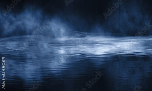 Dark empty scene, blue neon searchlight light, wet asphalt, smoke, night view, rays. Reflection on the water, night view. Liquid. 3d illustration.