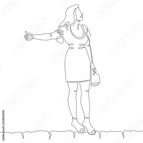 young woman catches a passing taxi car on the sidewalk, thumb up gesture
