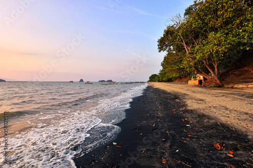 Beautiful sunset at black sand beach, Langkawi island, malaysia