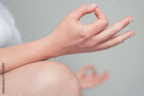 Closeup of woman hand in padmasana position yoga