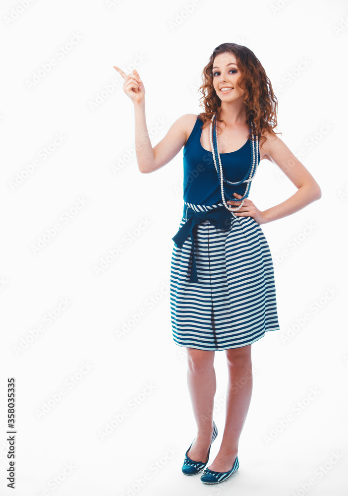 Fototapeta premium Smiling happy brunette woman pointing with finger aside isolated on white