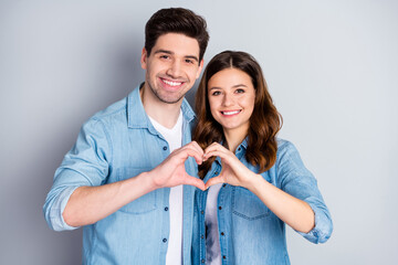 Photo pretty lady handsome guy couple in love making fingers hands heart figure celebrate anniversary valentine day lovers wear casual denim shirts outfit isolated grey color background