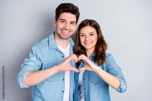 Photo pretty lady handsome guy couple in love making fingers hands heart figure celebrate anniversary valentine day lovers wear casual denim shirts outfit isolated grey color background photo