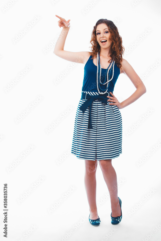 Smiling happy brunette woman pointing with finger aside isolated on white Smiling happy brunette woman pointing with finger aside isolated on white