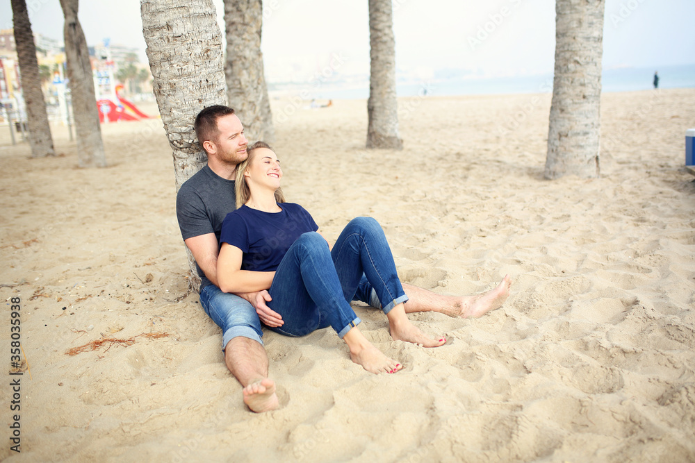 Romantic holidays on a sunny beach. Happy young people in love on the beach