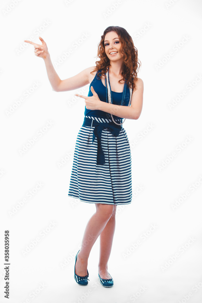 Fototapeta premium Smiling happy brunette woman pointing with finger aside isolated on white