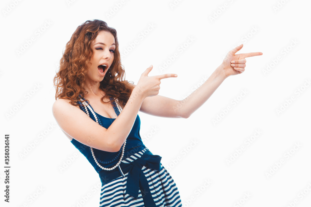 Smiling happy brunette woman pointing with finger aside isolated on white Smiling happy brunette woman pointing with finger aside isolated on white