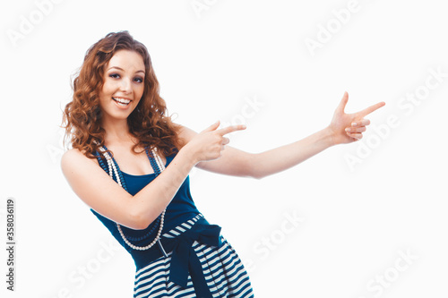 Smiling happy brunette woman pointing with finger aside isolated on white"