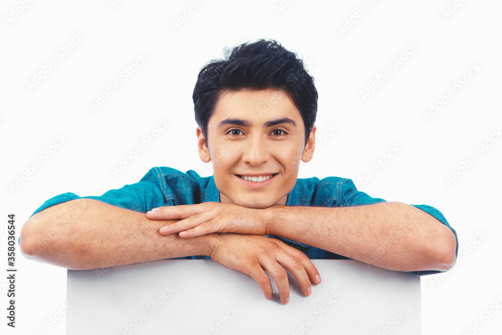 Fotografie Smiling cute man leaning on a banner