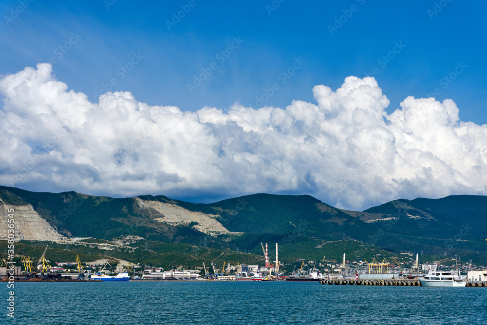 Clouds over mountains and port