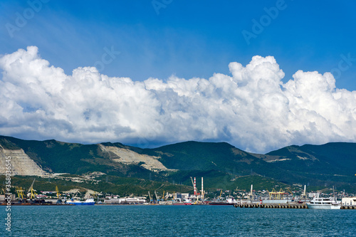 Clouds over mountains and port