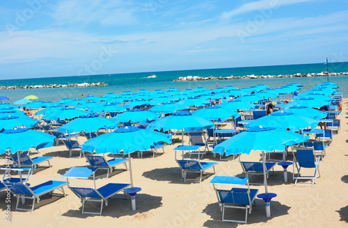 beach chairs and umbrellas on the beach © superpapero
