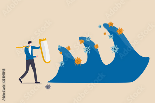 Business protection and immunity against COVID-19 Coronavirus second wave concept, bravely businessman leader holding strong shield to protect and control business from Coronavirus pathogen waves.