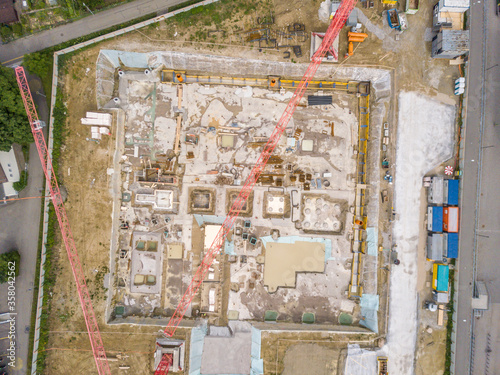 Aerial view of construction site in Switzerland with large crane.