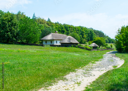 Rural house with a road .Ukrainian landscape.