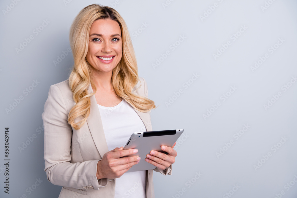 Close-up portrait of her she nice attractive charming skilled cheerful wavy-haired lady holding in hands using tablet finance hr it market research isolated on light white gray pastel color background Close-up portrait of her she nice attractive charming skilled cheerful wavy-haired lady holding in hands using tablet finance hr it market research isolated on light white gray pastel color background