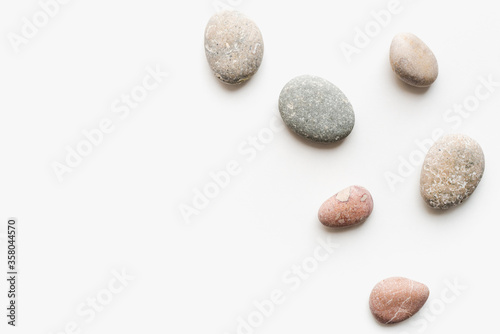 sea ​​stones on a white background, round stones, background of stones