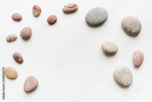 sea ​​stones on a white background, round stones, background of stones