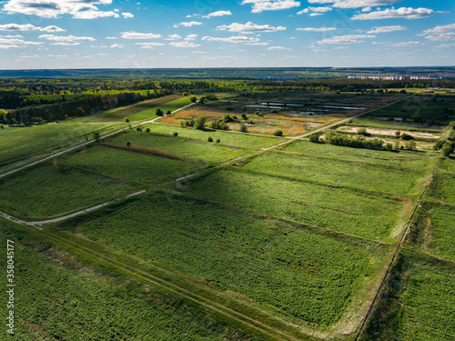 Overgrown natural sludge sumps for wastewater treatment, aerial view photo