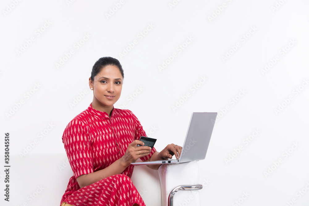 Young woman doing online shopping using credit card and laptop. Young woman doing online shopping using credit card and laptop.